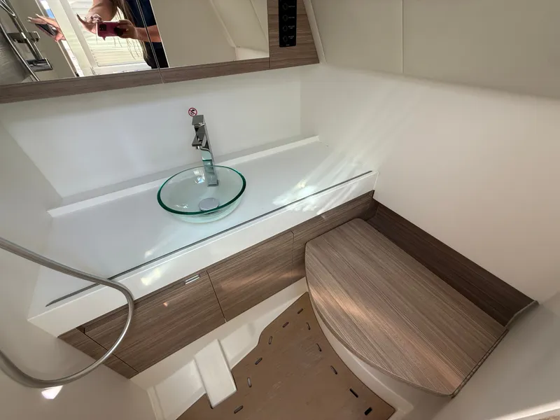 Slide: The Image of Modern bathroom with glass sink and wood accents on a boat. - 23