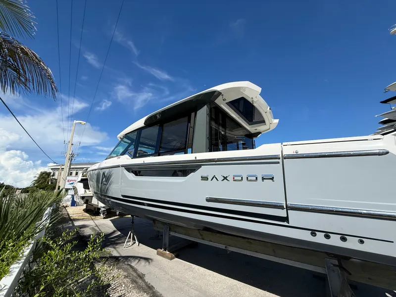 Slide: The Image of A Saxdor 400 GTC boat is on land under a clear blue sky. - 6