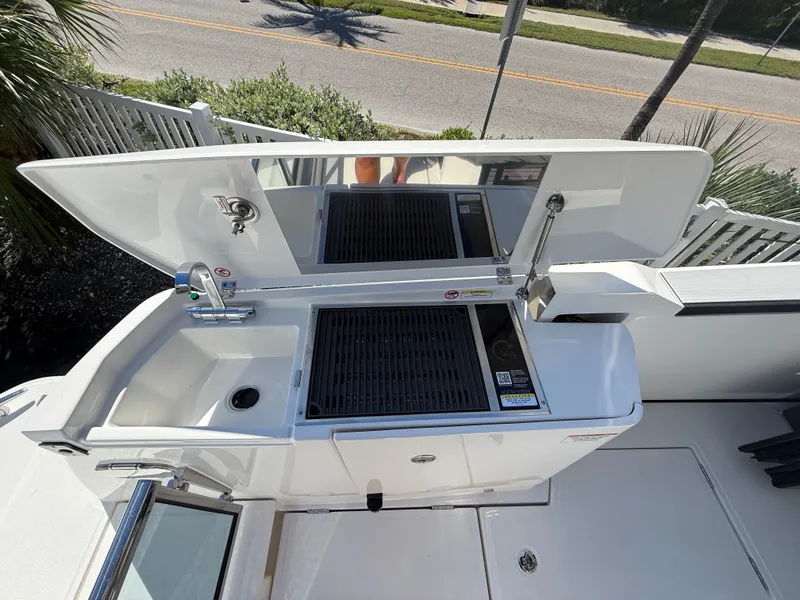 Slide: The Image of The 2027 Saxdor 400 GTC features a modern outdoor kitchen with a sink and grill. - 29