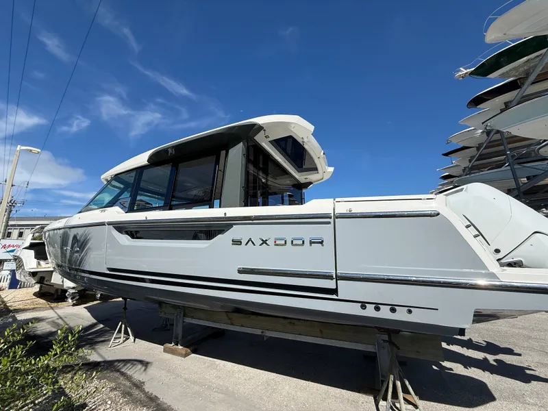 Slide: The Image of A 2027 Saxdor 400 GTC boat is on a dry dock under a blue sky. - 7