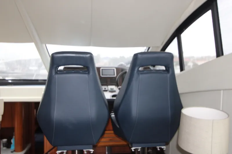 Slide: The Image of Interior of 2014 Sunseeker Manhattan 55 yacht with two blue captain chairs. - 12