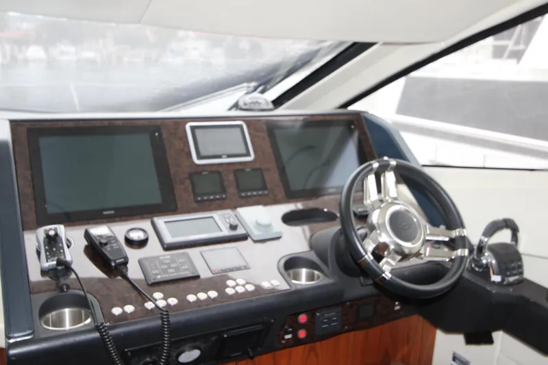 Slide: The Image of Cockpit of 2014 Sunseeker Manhattan 55 yacht with modern navigation controls and steering wheel. - 13