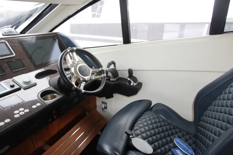 Slide: The Image of Luxurious helm of 2014 Sunseeker Manhattan 55 yacht with leather seating and modern controls. - 14