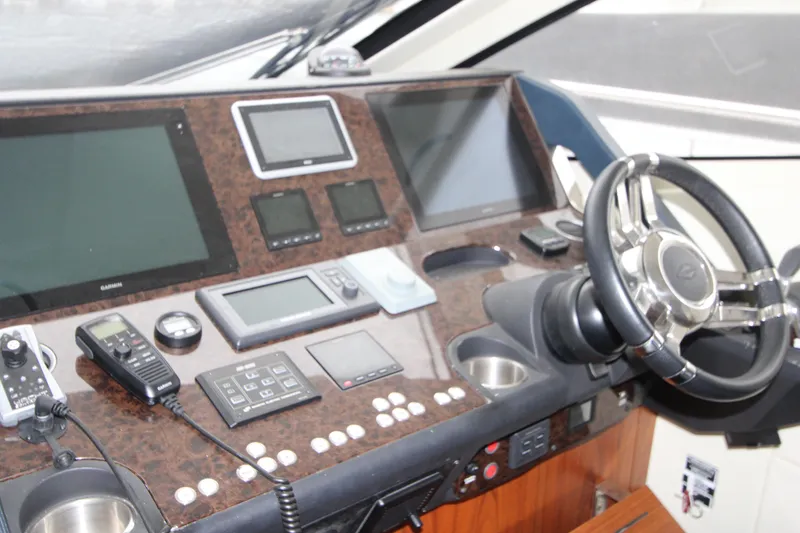Slide: The Image of Cockpit of 2014 Sunseeker Manhattan 55 yacht with navigation equipment and steering wheel. - 15