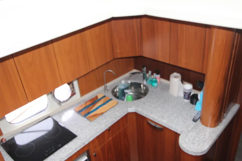 Slide: The Image of Luxurious kitchen area in a 2014 Sunseeker Manhattan 55 yacht with wooden cabinetry. - 16