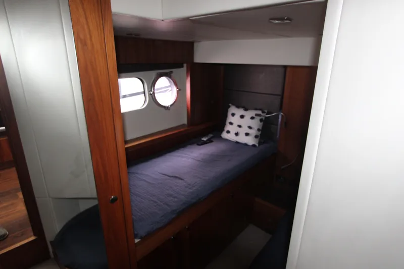 Slide: The Image of Cozy cabin interior of 2014 Sunseeker Manhattan 55 yacht with single bed and porthole. - 18