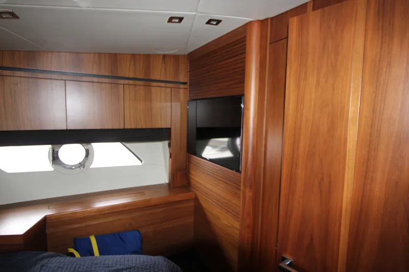 Slide: The Image of Interior cabin of 2014 Sunseeker Manhattan 55 yacht with wood paneling and porthole window. - 20
