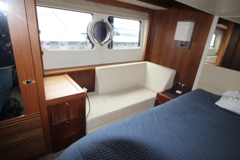 Slide: The Image of Interior of 2014 Sunseeker Manhattan 55 yacht with wood paneling and cozy seating area. - 24