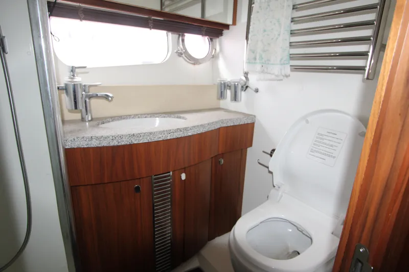 Slide: The Image of Luxurious bathroom in 2014 Sunseeker Manhattan 55 yacht with modern fixtures and wooden cabinetry. - 26