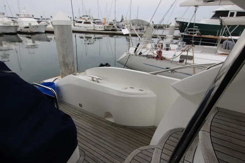 Slide: The Image of 2014 Sunseeker Manhattan 55 yacht docked at marina, showcasing sleek deck design. - 27