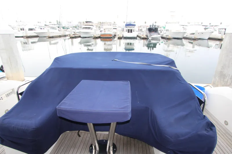 Slide: The Image of Covered deck area of a 2014 Sunseeker Manhattan 55 yacht in a marina. - 29