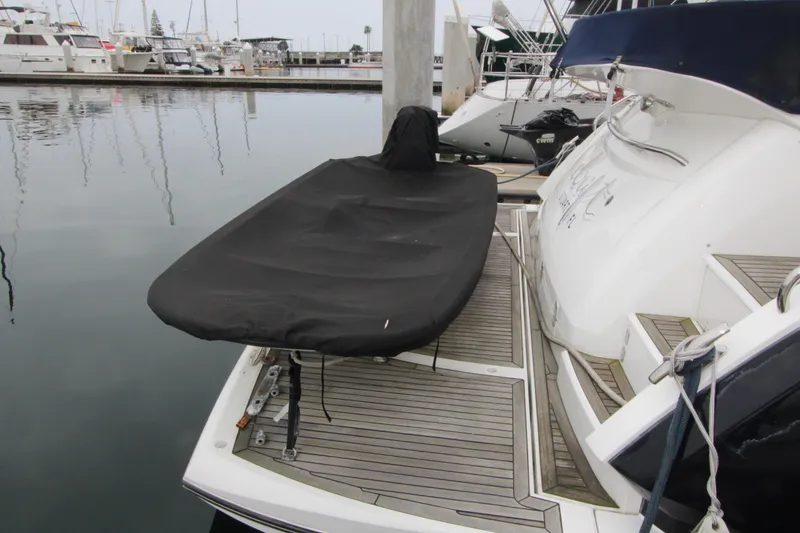 Slide: The Image of 2014 Sunseeker Manhattan 55 yacht docked, featuring covered equipment on the deck. - 3