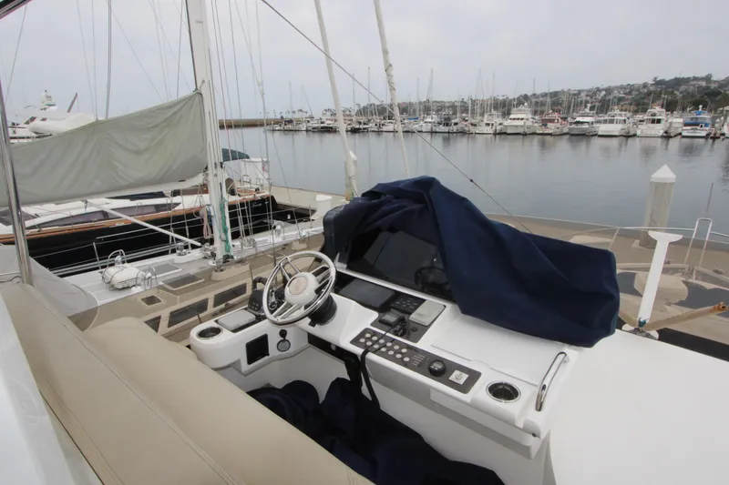 Slide: The Image of Helm of 2014 Sunseeker Manhattan 55 yacht docked at marina, featuring steering wheel and controls. - 31
