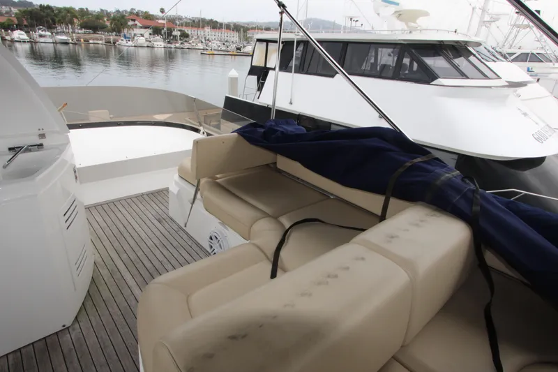Slide: The Image of 2014 Sunseeker Manhattan 55 yacht deck with beige seating and marina view. - 33