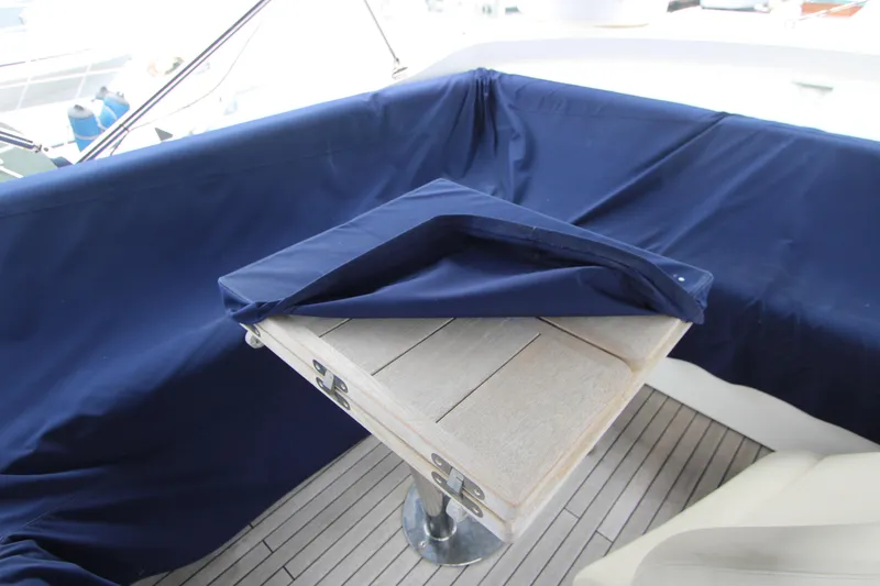 Slide: The Image of Sunseeker Manhattan 55 yacht deck with wooden table and blue cover, 2014 model. - 37