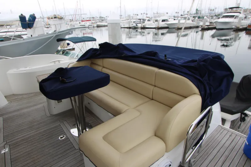 Slide: The Image of Luxurious seating area on a 2014 Sunseeker Manhattan 55 yacht, docked at a marina. - 38