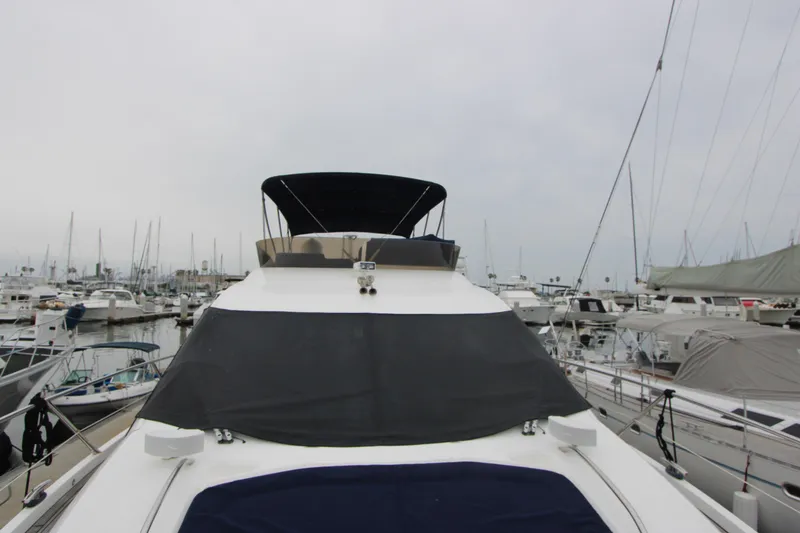 Slide: The Image of 2014 Sunseeker Manhattan 55 yacht docked in a marina, surrounded by other boats. - 39