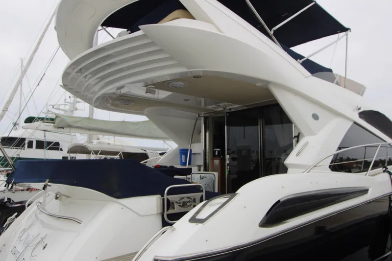 Slide: The Image of Luxury Sunseeker Manhattan 55 yacht, 2014 model, docked at marina with sleek design. - 4