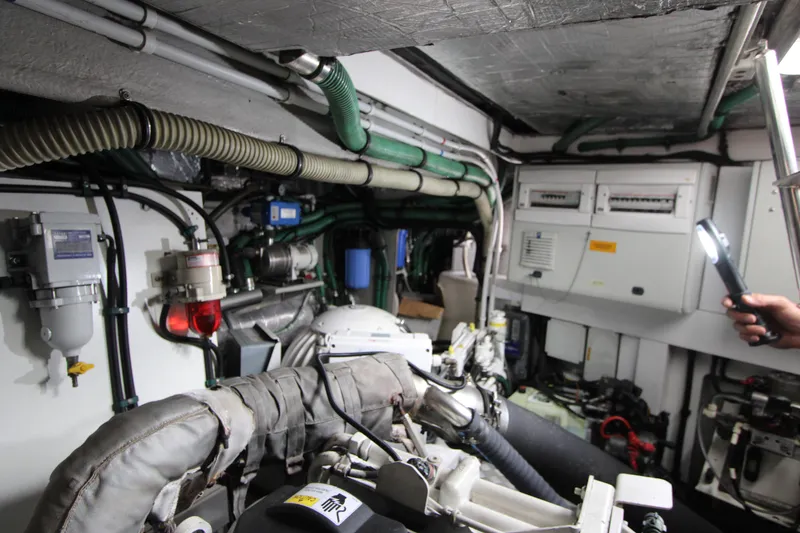 Slide: The Image of Engine room of 2014 Sunseeker Manhattan 55 yacht, showcasing mechanical components and wiring. - 44