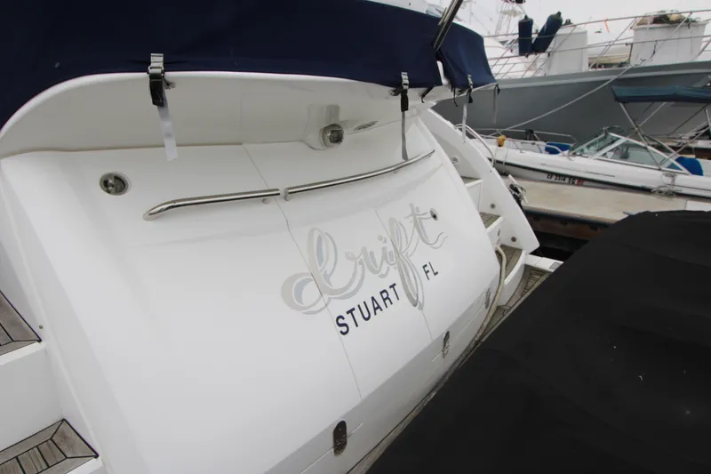 Slide: The Image of Sunseeker Manhattan 55 yacht, 2014 model, docked with "Drift" and "Stuart FL" on the stern. - 6