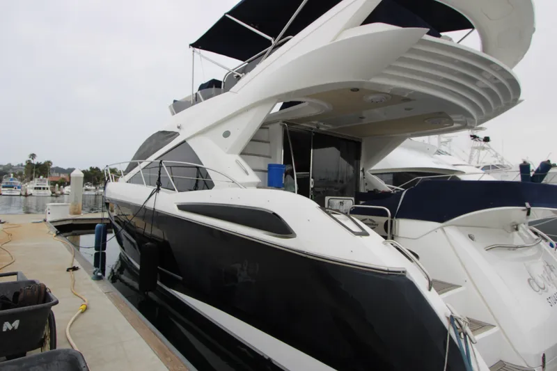 Slide: The Image of 2014 Sunseeker Manhattan 55 yacht docked at marina, showcasing sleek design and luxury features. - 7