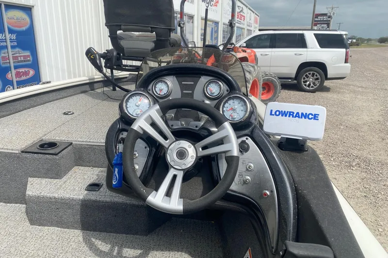 Slide: The Image of 2023 Tracker Pro Team 175 TF boat dashboard with steering wheel and Lowrance fish finder. - 7