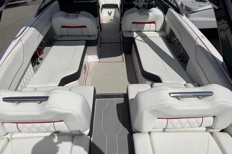 Slide: The Image of Luxurious interior of a 2021 Regal LS6 boat with white seating and red accents. - 16