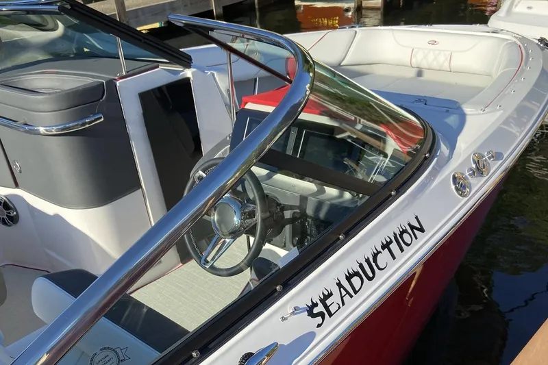 Slide: The Image of 2021 Regal LS6 boat with "Seaduction" name, sleek interior, and modern design. - 4