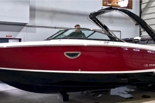 Slide: The Image of 2021 Regal LS6 boat in a showroom, featuring a sleek red and black design. - 5