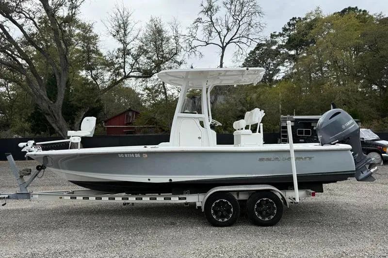 The Image of 2016 Sea Hunt BX 22 BR boat on trailer, parked outdoors with trees in background. - 1