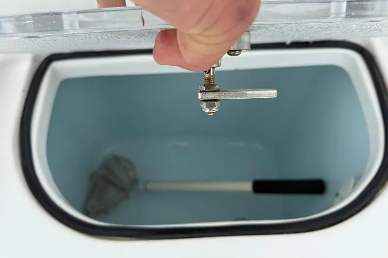 Slide: The Image of Hand opening storage compartment on 2016 Sea Hunt BX 22 BR boat. - 10