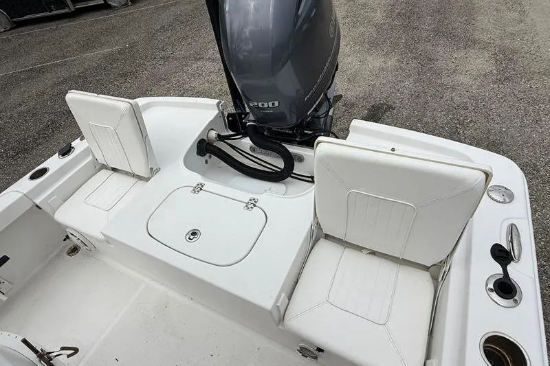 Slide: The Image of 2016 Sea Hunt BX 22 BR boat interior with seating and outboard motor. - 11