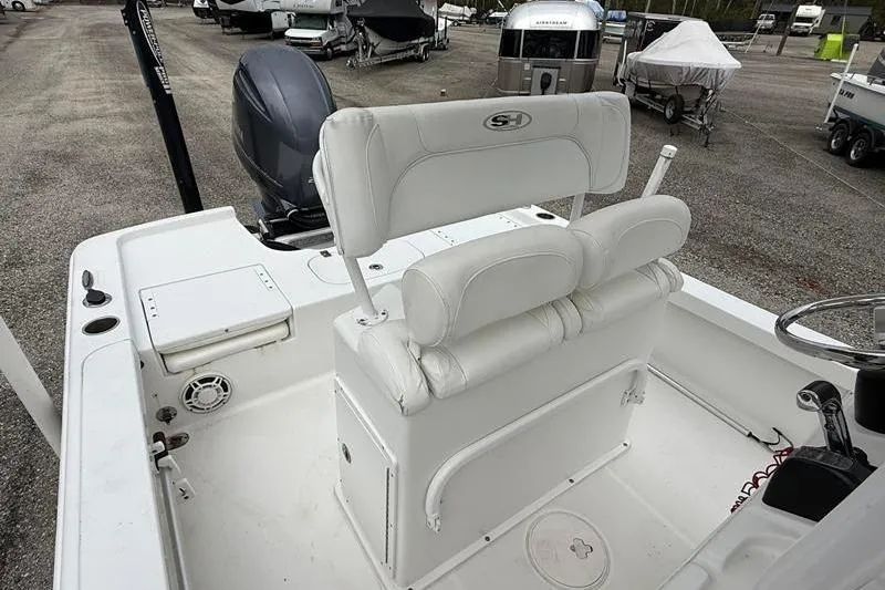 Slide: The Image of 2016 Sea Hunt BX 22 BR boat interior with white seating and console. - 16