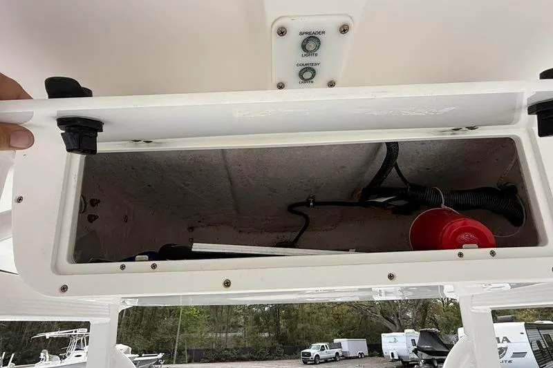 Slide: The Image of Storage compartment of a 2016 Sea Hunt BX 22 BR boat with wiring and controls. - 24