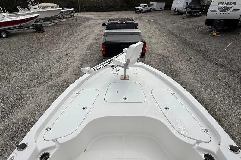 Slide: The Image of 2016 Sea Hunt BX 22 BR boat on trailer, parked in a gravel lot. - 25