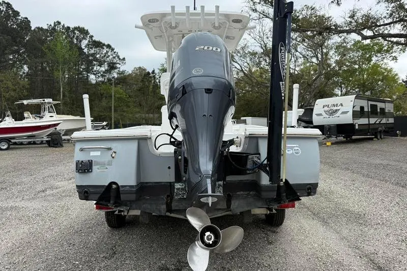 Slide: The Image of 2016 Sea Hunt BX 22 BR boat with Yamaha 200 engine, parked outdoors. - 3