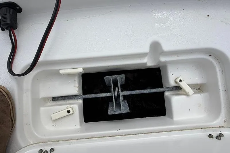 Slide: The Image of 2016 Sea Hunt BX 22 BR boat anchor storage compartment with wiring visible. - 34