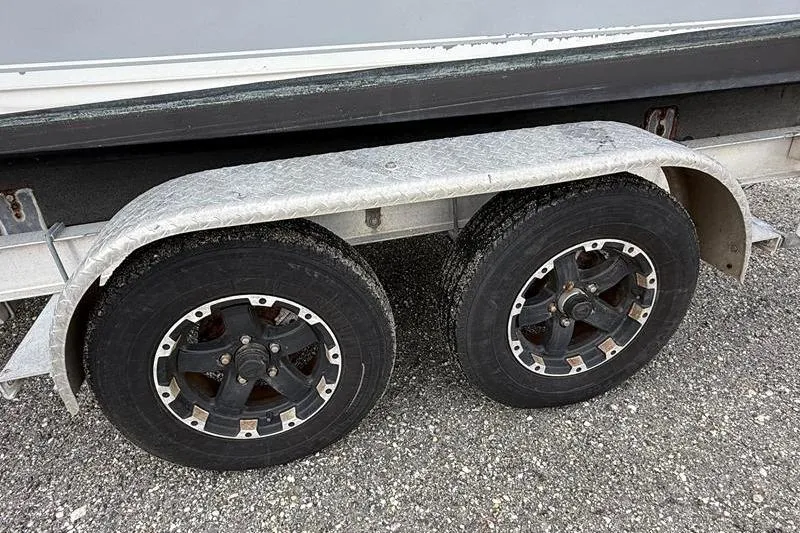 Slide: The Image of Trailer wheels of a 2016 Sea Hunt BX 22 BR boat on gravel surface. - 40