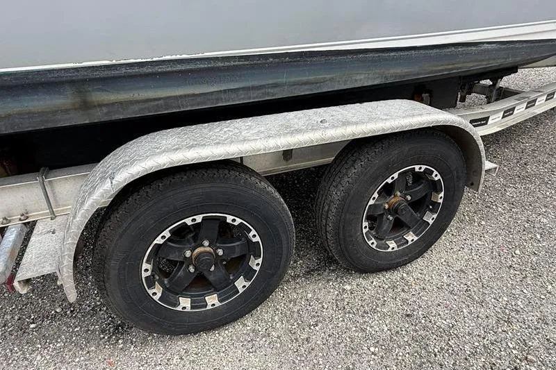 Slide: The Image of Trailer wheels of a 2016 Sea Hunt BX 22 BR boat on gravel. - 41
