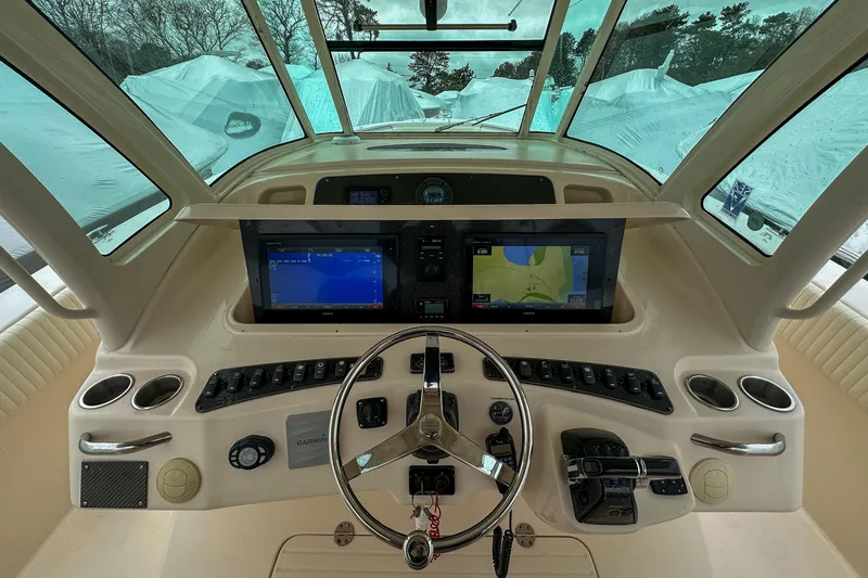 Slide: The Image of 2011 Grady-White Canyon 366 helm with dual navigation screens and steering wheel. - 12