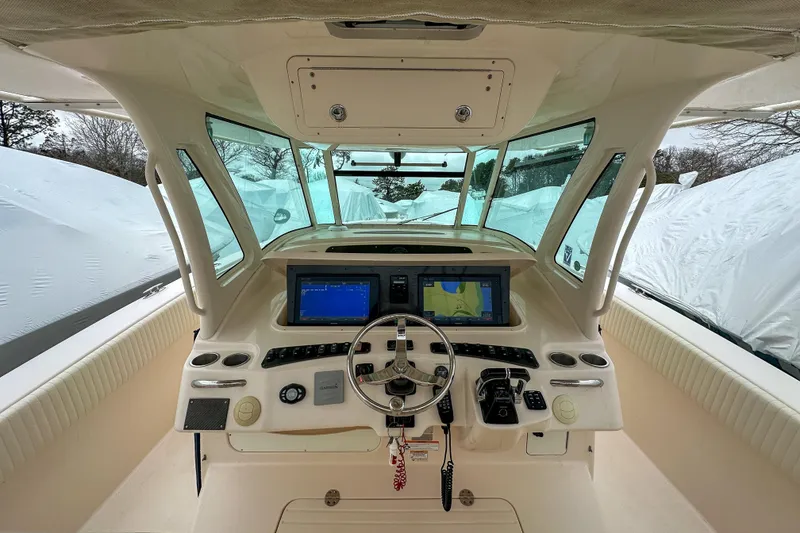Slide: The Image of 2011 Grady-White Canyon 366 helm with dual navigation screens and steering wheel. - 14
