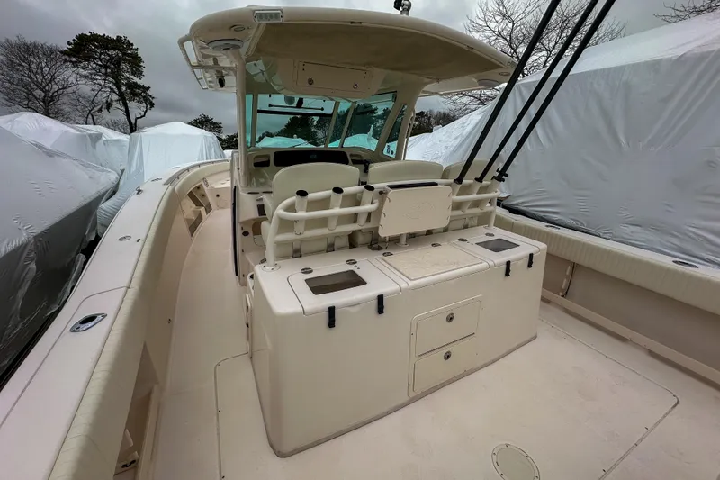 Slide: The Image of 2011 Grady-White Canyon 366 boat interior with fishing rod holders and storage compartments. - 16