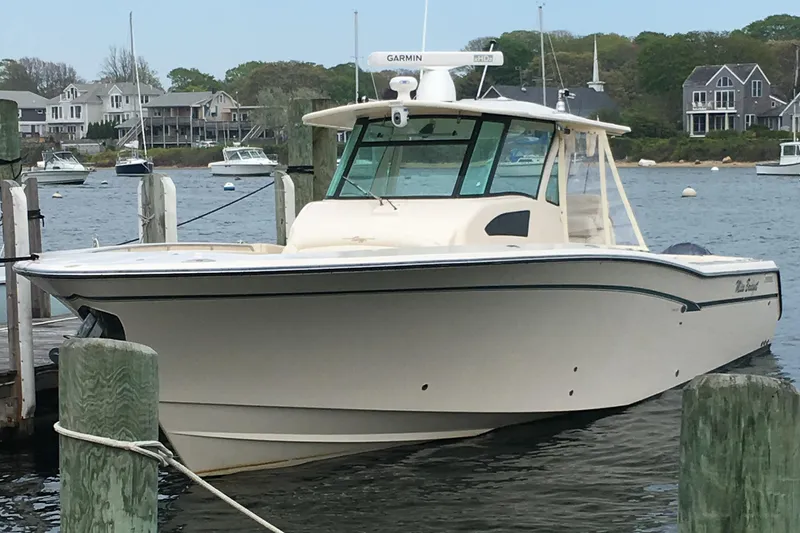 Slide: The Image of 2011 Grady-White Canyon 366 boat docked in a scenic marina setting. - 2
