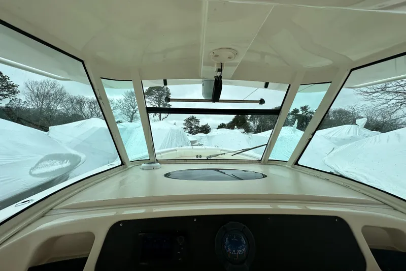 Slide: The Image of Interior view of 2011 Grady-White Canyon 366 boat, surrounded by covered vessels. - 20