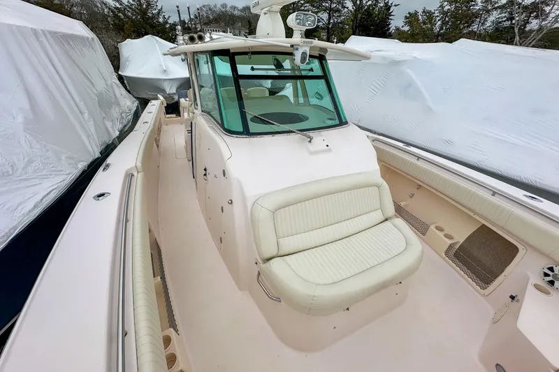 Slide: The Image of 2011 Grady-White Canyon 366 boat with cushioned seating and covered storage. - 24
