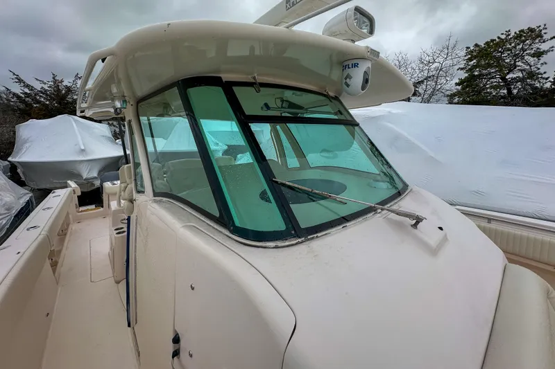 Slide: The Image of 2011 Grady-White Canyon 366 boat with windshield and FLIR camera, docked outdoors. - 25