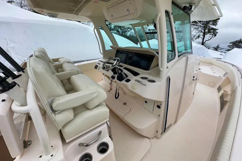 Slide: The Image of 2011 Grady-White Canyon 366 boat interior with helm, seating, and controls. - 27