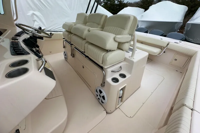 Slide: The Image of 2011 Grady-White Canyon 366 boat interior with helm seating and control panel. - 28