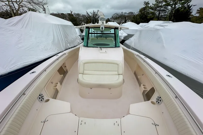 Slide: The Image of 2011 Grady-White Canyon 366 boat with spacious deck and seating, covered in storage area. - 30