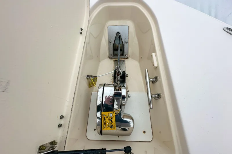 Slide: The Image of Anchor compartment of 2011 Grady-White Canyon 366 boat, featuring a polished winch system. - 39